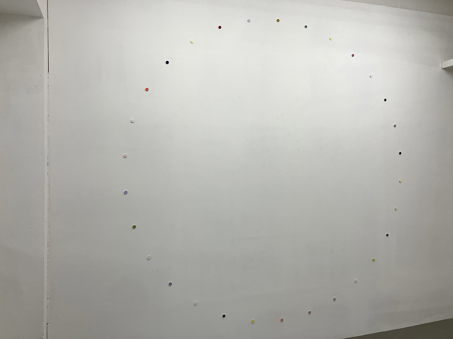 a small wheel, pigment, casein on aluminum, 22 x 6 mm (each), 250 x 250 cm (overall), 2025<br><br>